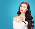 Portrait of beautiful young woman with dark wavy hair in a white knitted sweater. Makeup and bright red lips Royalty Free Stock Photo