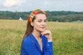 Portrait of a beautiful young woman in a decorative headband on her head in a meadow Royalty Free Stock Photo