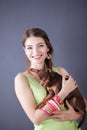Portrait of the beautiful young woman with dog on the grey background Royalty Free Stock Photo