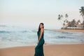 Portrait of beautiful young woman in dress on the beach. Pretty girl on tropical beach. Freedom concept, holida