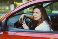 Portrait of beautiful young woman driver behind wheel red car Royalty Free Stock Photo