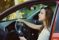 Portrait of beautiful young woman driver behind wheel red car Royalty Free Stock Photo