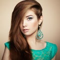 Portrait of beautiful young woman with earring. Jewelry and accessories