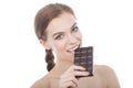 Portrait of a beautiful young woman eating a chocolate bar. Royalty Free Stock Photo