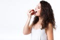Beautiful young woman eating red apple over white background. Royalty Free Stock Photo