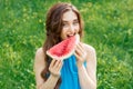 Portrait of a beautiful young woman is eating slice of watermelon Royalty Free Stock Photo