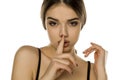Portrait of beautiful young woman with with finger on her lips Royalty Free Stock Photo