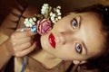 Portrait of beautiful young woman with flowers