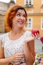 Portrait of the beautiful young woman with fresh red apple. Girl smile and enjoy eating appetizing and juicy apple Royalty Free Stock Photo