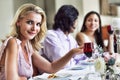 Portrait of beautiful young woman with friends at diner party Royalty Free Stock Photo