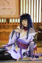 Portrait of a beautiful young woman game cosplay with samurai dress costume on Japanese garden Royalty Free Stock Photo