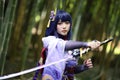 Portrait of a beautiful young woman game cosplay with samurai dress costume on Japanese garden Royalty Free Stock Photo