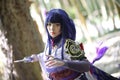 Portrait of a beautiful young woman game cosplay with samurai dress costume on Japanese garden Royalty Free Stock Photo