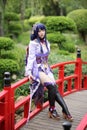 Portrait of a beautiful young woman game cosplay with samurai dress costume on Japanese garden Royalty Free Stock Photo