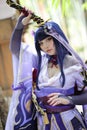 Portrait of a beautiful young woman game cosplay with samurai dress costume on Japanese garden