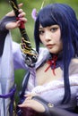 Portrait of a beautiful young woman game cosplay with samurai dress costume on Japanese garden Royalty Free Stock Photo