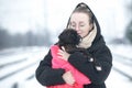 Portrait of a beautiful young woman with a german boxer puppy on a winter walk Royalty Free Stock Photo