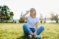 Portrait of a beautiful young woman or girl on very green meadow watching the sunset enjoying nature summer evening outdoors. Royalty Free Stock Photo