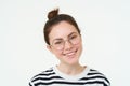 Portrait of beautiful young woman in glasses, wearing eyewear, smiling and looking happy, trying on new spectacles Royalty Free Stock Photo