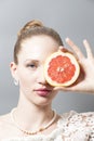 Portrait of Beautiful young woman with grapefruit in her hand Royalty Free Stock Photo