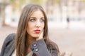 Portrait of beautiful young woman with green eyes thinking.