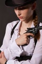 Portrait of beautiful young woman with a gun. Royalty Free Stock Photo