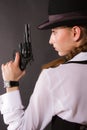 Portrait of beautiful young woman with a gun. Royalty Free Stock Photo