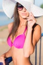 Portrait of beautiful young woman in hat posing in bikini on the beach Royalty Free Stock Photo