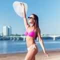 Portrait of beautiful young woman in hat posing in bikini on the beach Royalty Free Stock Photo