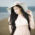 Portrait of a beautiful young woman in hat in summer