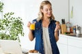 Beautiful young woman having breakfast in the kitchen. Royalty Free Stock Photo