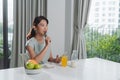 Portrait of beautiful young woman having breakfast in the kitchen Royalty Free Stock Photo