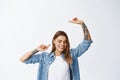 Portrait of beautiful young woman having fun, smiling happy and raising hands up free, dancing carefree, standing in Royalty Free Stock Photo