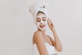 Portrait of beautiful young woman having fun with towels after take bath make cosmetic mask on her face. Rejuvenation
