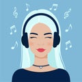 Portrait of a beautiful young woman with headphones. Girl with blond hair listens to music.