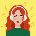 Portrait of a beautiful young woman with headphones. Girl with red hair listens to music.