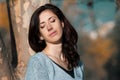 Portrait of a beautiful young woman with her eyes closed against a tree and autumn yellow foliage Royalty Free Stock Photo