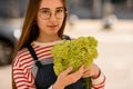 portrait of beautiful young woman holding bouquet of fresh light green carnation in her hands Royalty Free Stock Photo