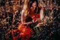 portrait of a beautiful young woman holding bouquet of red poppies. magic light effect. Royalty Free Stock Photo