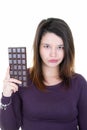 Portrait of beautiful young woman holding chocolate bar sad Royalty Free Stock Photo