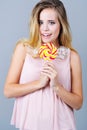 Portrait of a beautiful young woman holding colorful candy Royalty Free Stock Photo