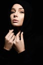 Portrait of beautiful young woman in hood. pretty religious girl