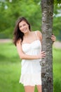 Portrait of a beautiful young woman hugging a tree Royalty Free Stock Photo