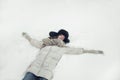 Portrait of a beautiful young woman laying down on a snow angel figure