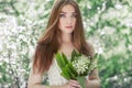 Portrait of beautiful young woman with lily of the valley Royalty Free Stock Photo