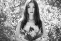 Portrait of beautiful young woman with lily of the valley