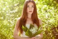 Portrait of beautiful young woman with lily of the valley Royalty Free Stock Photo