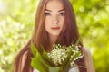 Portrait of beautiful young woman with lily of the valley Royalty Free Stock Photo