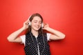 Portrait of beautiful young woman listening to music against color background Royalty Free Stock Photo