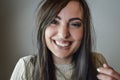 Portrait of a beautiful young woman with long brown hair laughing happily Royalty Free Stock Photo